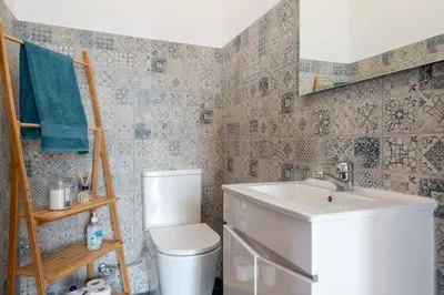 a bathroom with a toilet and a sink at Casa da Silva home in Funchal in Funchal