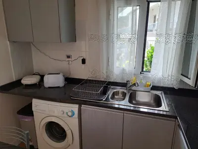 a kitchen with a sink and a washing machine at Success House in Calheta