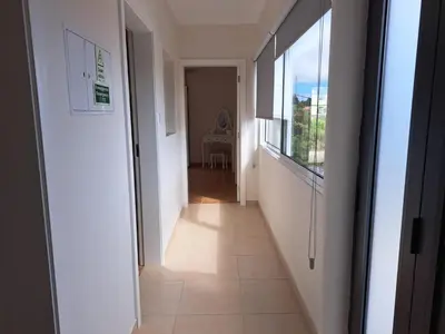 a hallway leading to a room with a window at Success House in Calheta