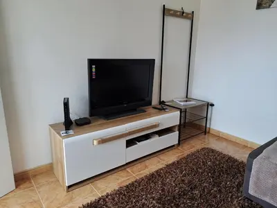 a flat screen tv sitting on top of a white entertainment center at Success House in Calheta