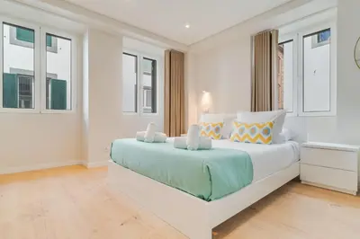 a white bedroom with a large bed and windows at Q Studios by Atlantic Holiday in Funchal
