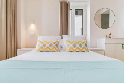 a bedroom with a large bed with two pillows at Q Studios by Atlantic Holiday in Funchal