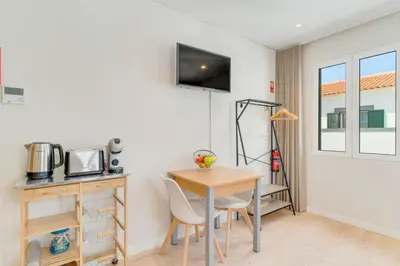 a small kitchen with a table and chairs in a room at Q Studios by Atlantic Holiday in Funchal