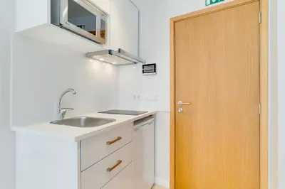 a kitchen with a sink and a wooden door at Q Studios by Atlantic Holiday in Funchal