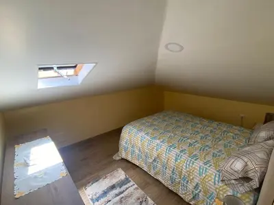a small bedroom with a bed and a window at Casinha Gomes in Calheta