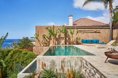 a swimming pool in the backyard of a house at Pirate House Sea front Private Pool Garden Funchal in Funchal