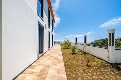 a balcony of a house with a view of the ocean at SUPER Camacha - Casa da Eira in Camacha