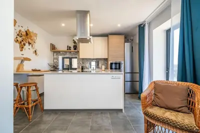 a kitchen with a large white island in a room at SUPER Camacha - Casa da Eira in Camacha