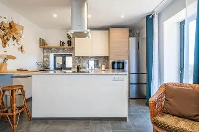 a kitchen with a large white island in a room at SUPER Camacha - Casa da Eira in Camacha