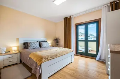 a bedroom with a bed and a large window at SUPER Top Floor in Funchal