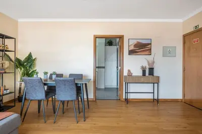 a living room with a dining room table and chairs at SUPER Top Floor in Funchal