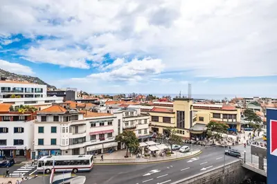 a city with a bus on a street at SUPER Top Floor in Funchal