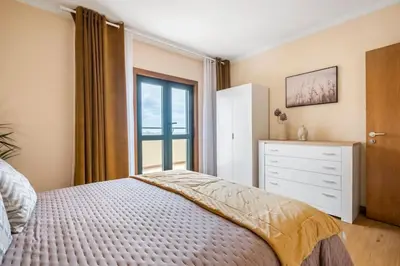 a bedroom with a bed and a dresser and a window at SUPER Top Floor in Funchal