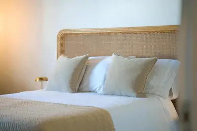 a bed with white sheets and pillows at Aldeia in Chã de João Tomé