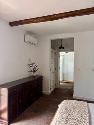 a bedroom with a bed and a dresser in a room at Aldeia in Chã de João Tomé