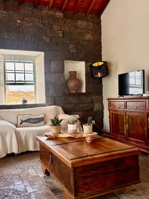 a living room with a couch and a coffee table at Aldeia in Chã de João Tomé