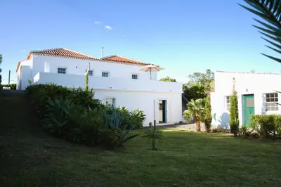 a white house with a yard in front of it at Aldeia in Chã de João Tomé