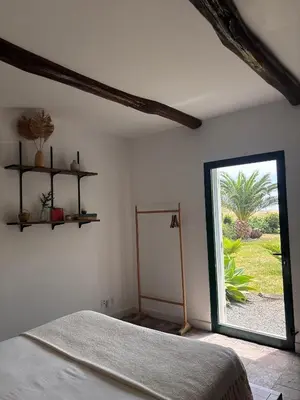 a bedroom with a bed and a large window at Aldeia in Chã de João Tomé