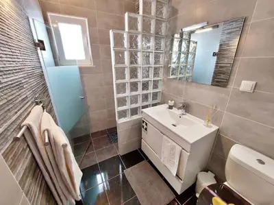 a bathroom with a white sink and a mirror at Sea View 2-beds 'Estrela' Apartment - Praia da Luz in Luz