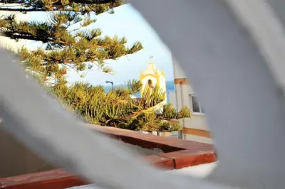 a view of a church through a window at Sea View 2-beds 'Estrela' Apartment - Praia da Luz in Luz