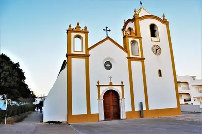 a church with a clock on the side of it at Sea View 2-beds 'Estrela' Apartment - Praia da Luz in Luz