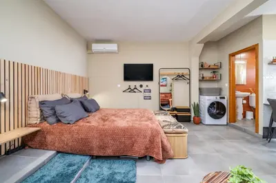 a bedroom with a bed and a tv on the wall at SUPER Seixal Beach - T0 in Seixal