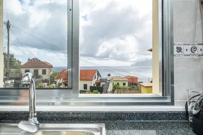 a kitchen window with a sink and a view at SUPER Seixal Beach - T0 in Seixal