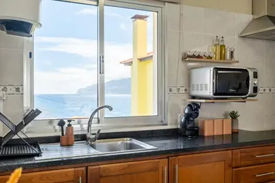 a kitchen with a sink and a window at SUPER Seixal Beach - T0 in Seixal