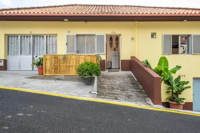 a yellow house with a wooden fence in front of it at SUPER Seixal Beach - T2 in Seixal