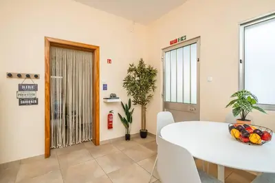 a dining room with a white table and chairs at SUPER Seixal Beach - T2 in Seixal