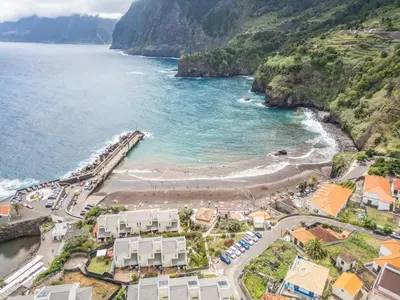 an aerial view of a beach next to the ocean at SUPER Seixal Beach - T2 in Seixal