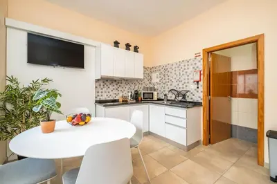 a kitchen with a white table and a white counter top at SUPER Seixal Beach - T2 in Seixal