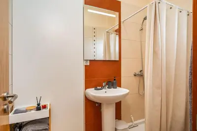 a white bathroom with a sink and a shower at SUPER Seixal Beach - T2 in Seixal