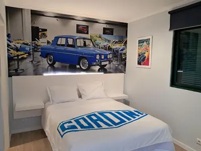 a bedroom with a bed with a blue car on the wall at Classic Car House in Santa Cruz