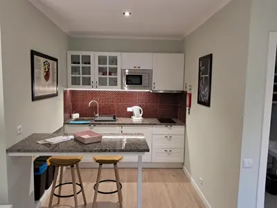 a kitchen with a counter and two bar stools at Classic Car House in Santa Cruz
