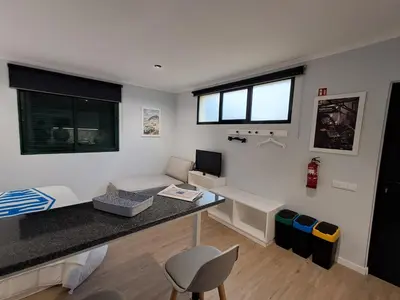 a small room with a desk and a couch at Classic Car House in Santa Cruz