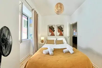 a bedroom with a large bed with two pillows at Madeira Breeze in Funchal