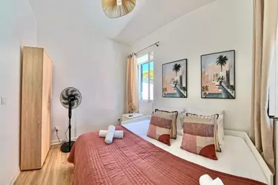 a bedroom with a bed and a window and a fan at Madeira Breeze in Funchal