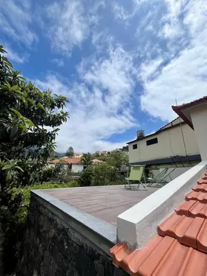 a patio with a chair on top of a house at Villa with Mountain view, São Vicente, Madeira in São Vicente