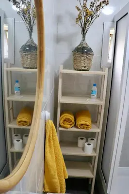 a bathroom with a mirror and towels and two baskets at Villa with Mountain view, São Vicente, Madeira in São Vicente