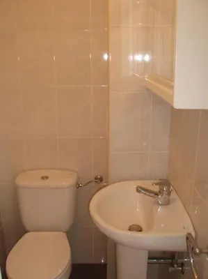 a bathroom with a white toilet and a sink at Villa with Mountain view, São Vicente, Madeira in São Vicente