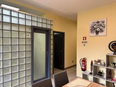 a dining room with a glass wall with a door at Xanda Escape in Machico