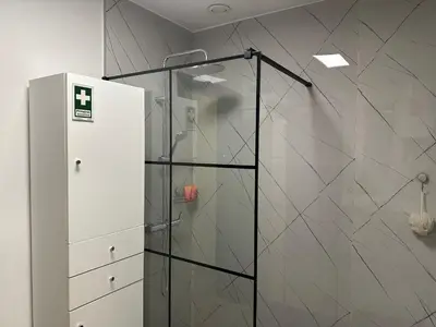 a shower with a glass door in a bathroom at Xanda Escape in Machico