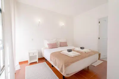 a bedroom with a bed with two trays on it at 5 bedroom Beach house in Luz, Lagos in Luz