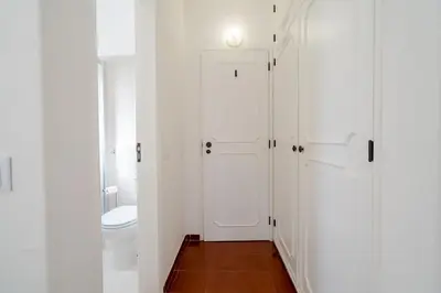 a bathroom with a toilet and a white door at 5 bedroom Beach house in Luz, Lagos in Luz
