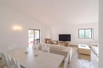 a living room with a table and a couch at 5 bedroom Beach house in Luz, Lagos in Luz