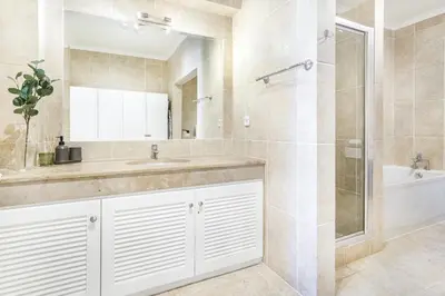 a bathroom with a sink and a shower at Vila Agora Luz in Luz