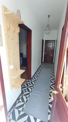a hallway with a staircase and a door with a tile floor at Bus Stop House 82 in Funchal