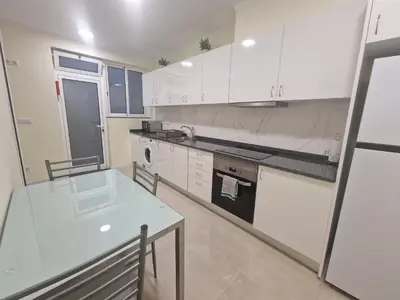 a kitchen with white cabinets and a white counter top at Atlantic Garden Santa Luzia 44 in Funchal