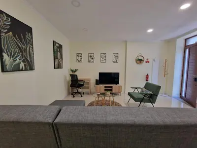 a living room with a couch and chairs and a television at Atlantic Garden Santa Luzia 44 in Funchal